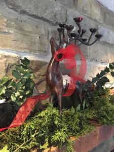 Decorated mantle with greenery, ribbon, and a nice candelabra