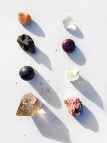 Left row: Winter Solstice crystals (from top: sunstone, staurolyte, merlinite, smoky quartz) Right row: Summer Solstice crystals (from top: white topaz, ruby, green apophyllite, rhodonite)