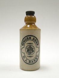 A tan and beige stoneware jar of ginger beer